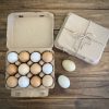 Hatching Time. Henlay Vintage white 12ct chicken egg cartons shown on table filled next to carton closed with twine.